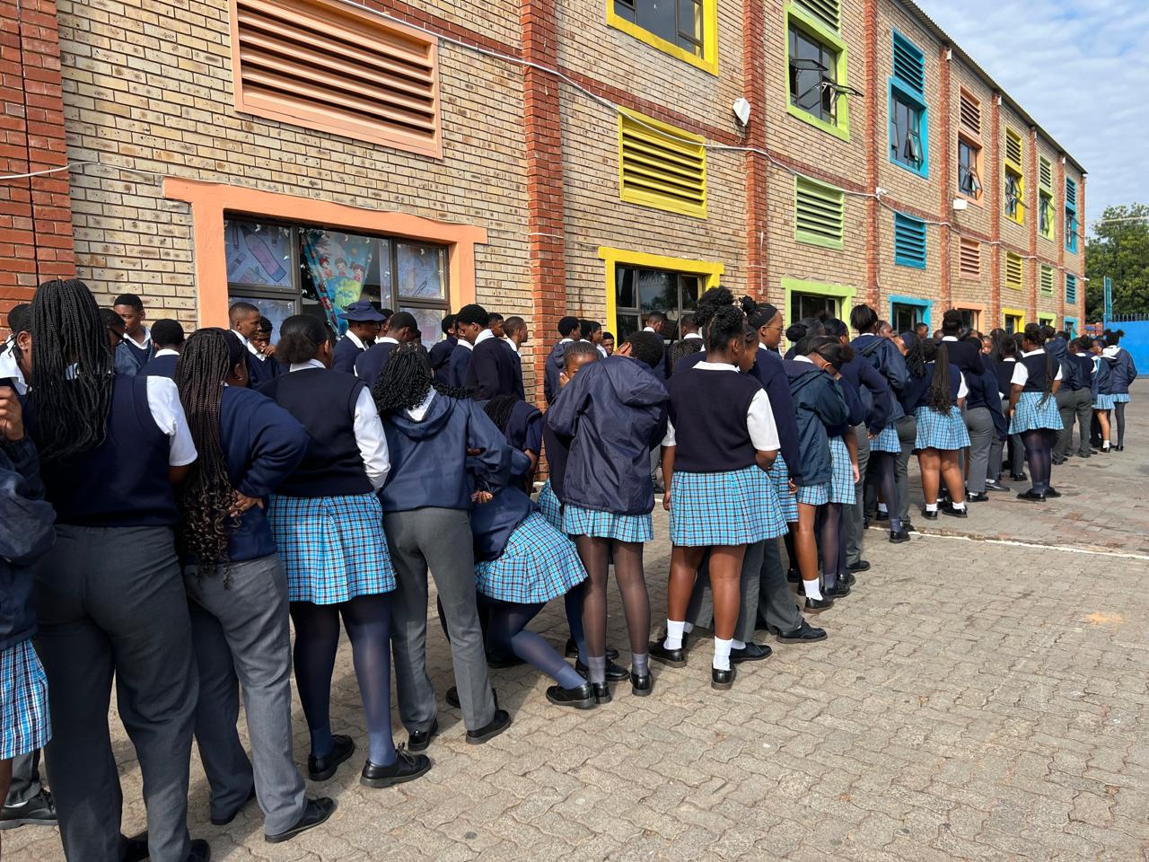 North Angelos Christian College learners lining up outside the school building